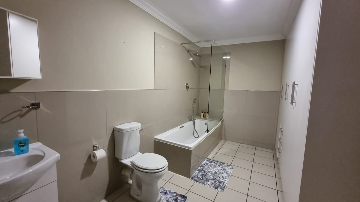 Full bathroom with bath/shower combo and walk-in closet.