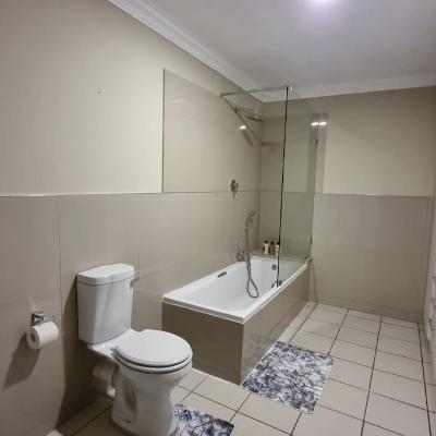 Full bathroom with bath/shower combo and walk-in closet.
