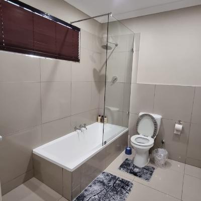 Full bathroom with bath/shower combo with walk-in closet.