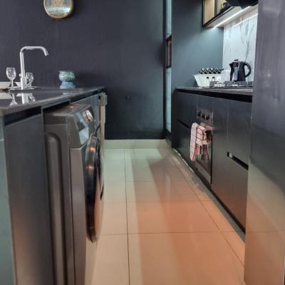 Fully equipped kitchen with washer/dryer combo, dishwasher and gas stove and oven