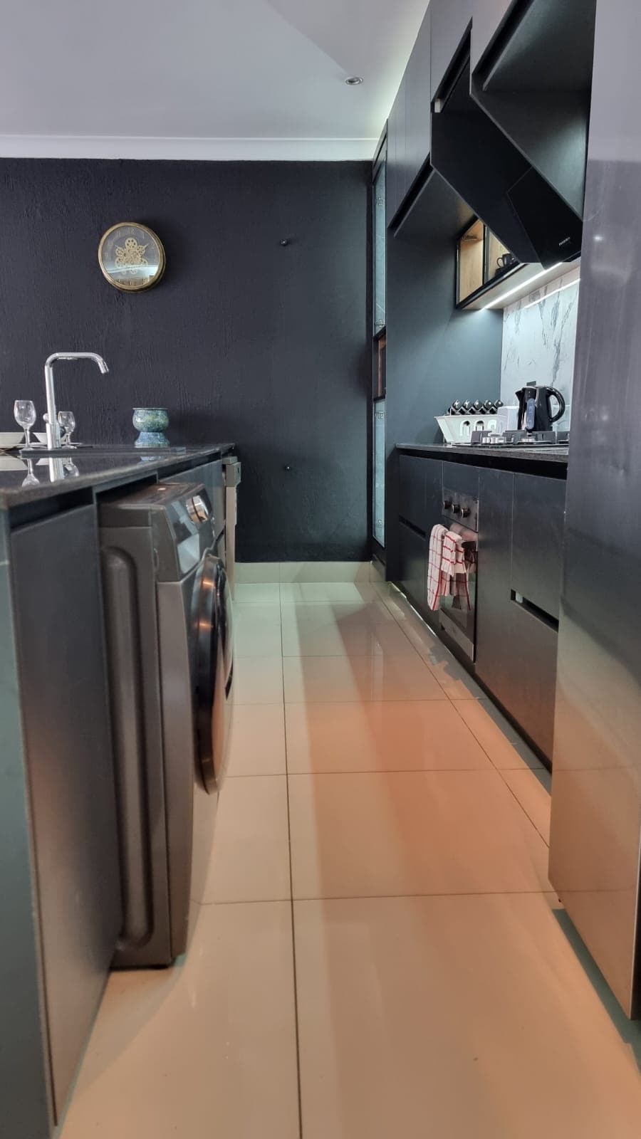 Fully equipped kitchen with washer/dryer combo, dishwasher and gas stove and oven