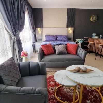 Couch set and double bed with usb charging ports on side tables.