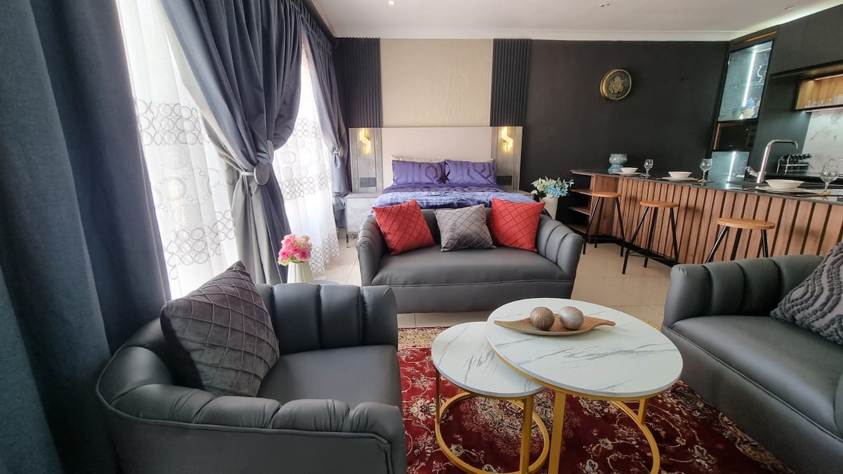 Couch set and double bed with usb charging ports on side tables.