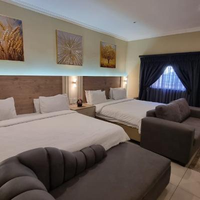 Two LED-lit king sized beds side by side that sleeps four comfortably. Electric blankets installed on the beds.