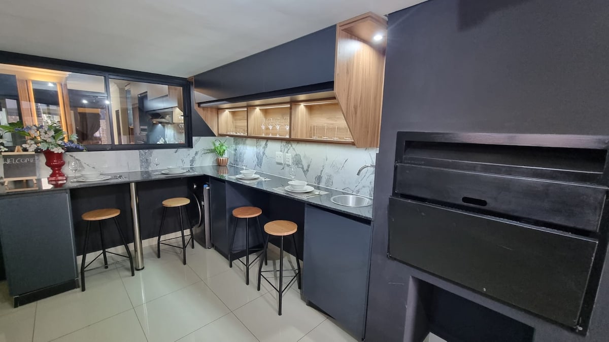 Indoor BBQ/Braai grill and kitchen and bar seating area.