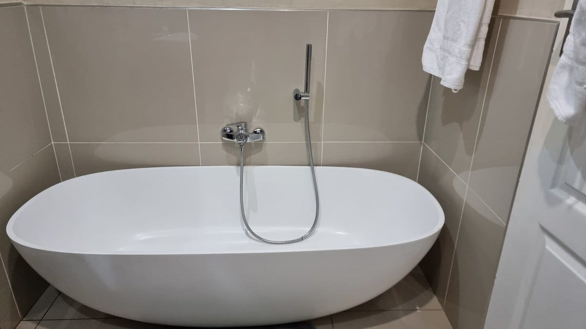 Full bathroom with shower and bathtub.