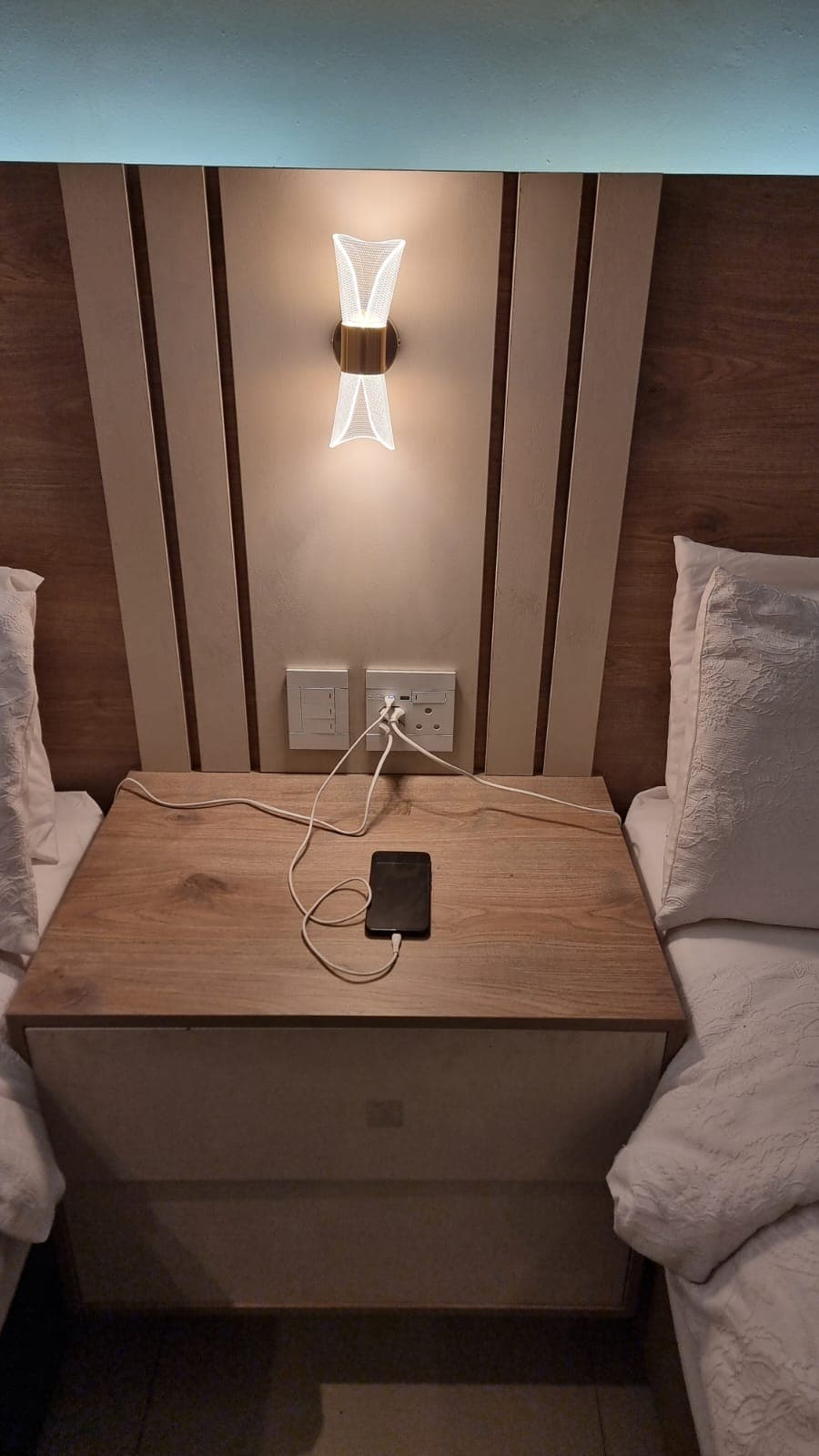USB ports and plugs at bed side for charging.