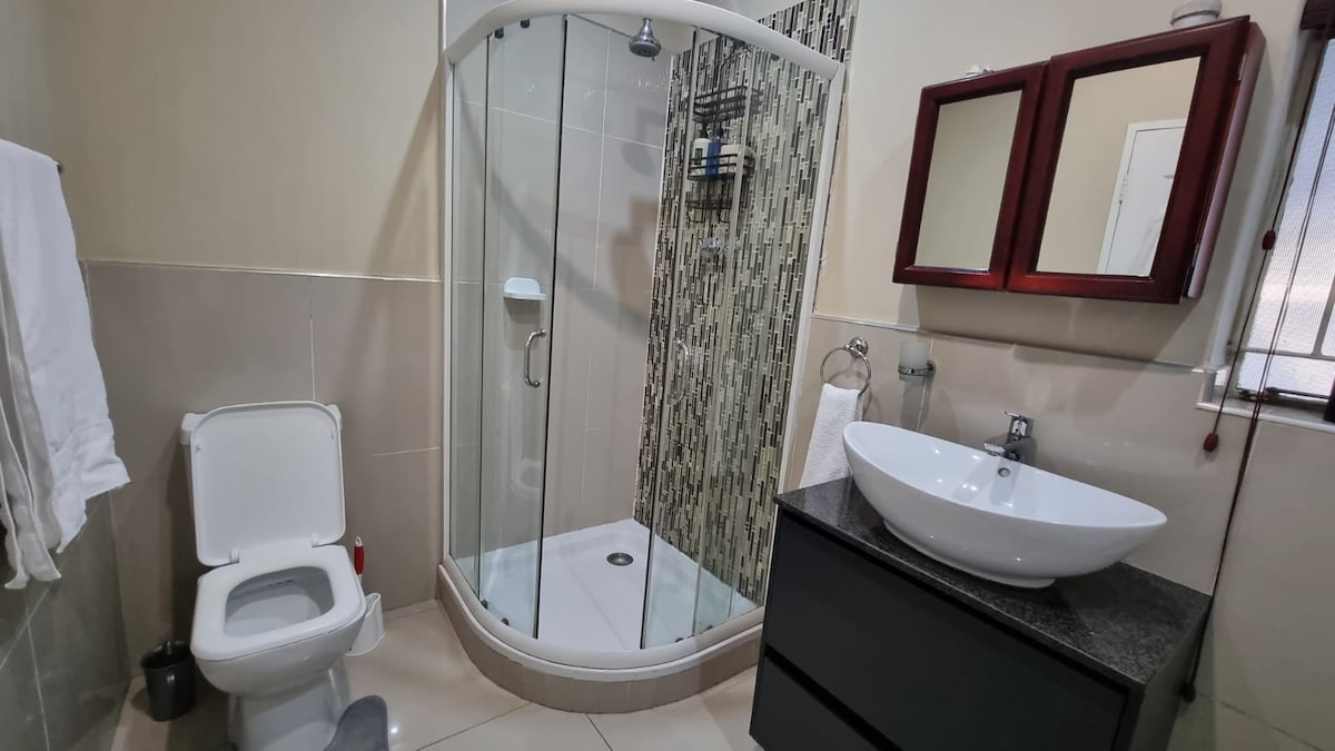 Full bathroom with shower and bathtub.