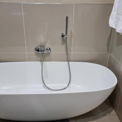 Full bathroom with shower and bathtub.