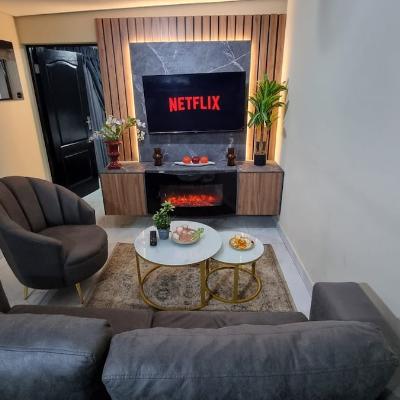 Led Lit living room with smart TV with with netflix subscription and LED fireplace heater.