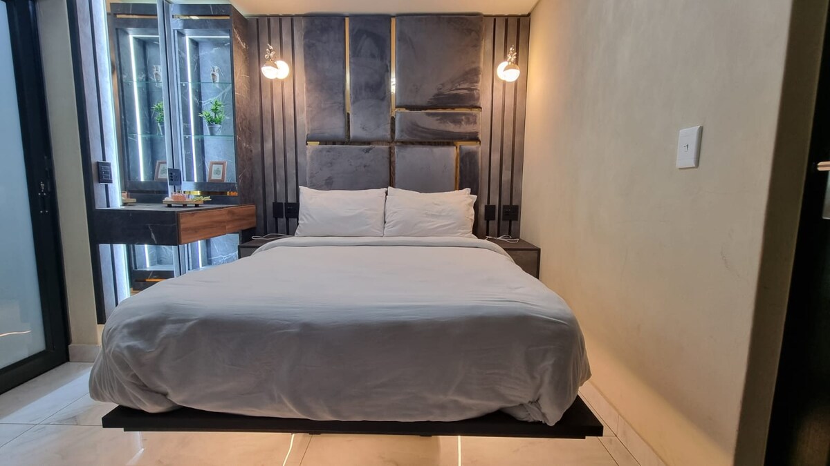 LED lit floating bed with ensuite bathroom.