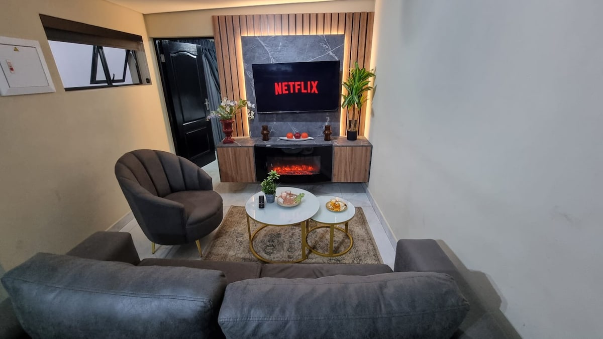 Led Lit living room with smart TV with with netflix subscription and LED fireplace heater.