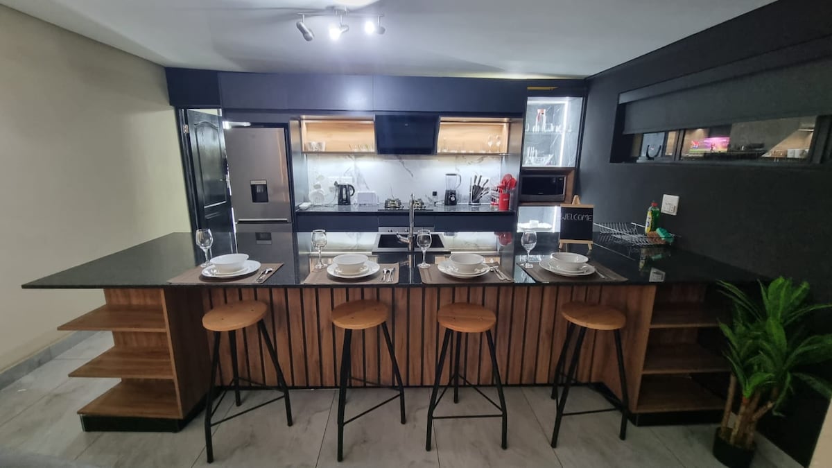 Full kitchen with gas stove and oven, microwave oven, blender, toaster, kettle, fridge, washer/dryer combo, and dishwasher.