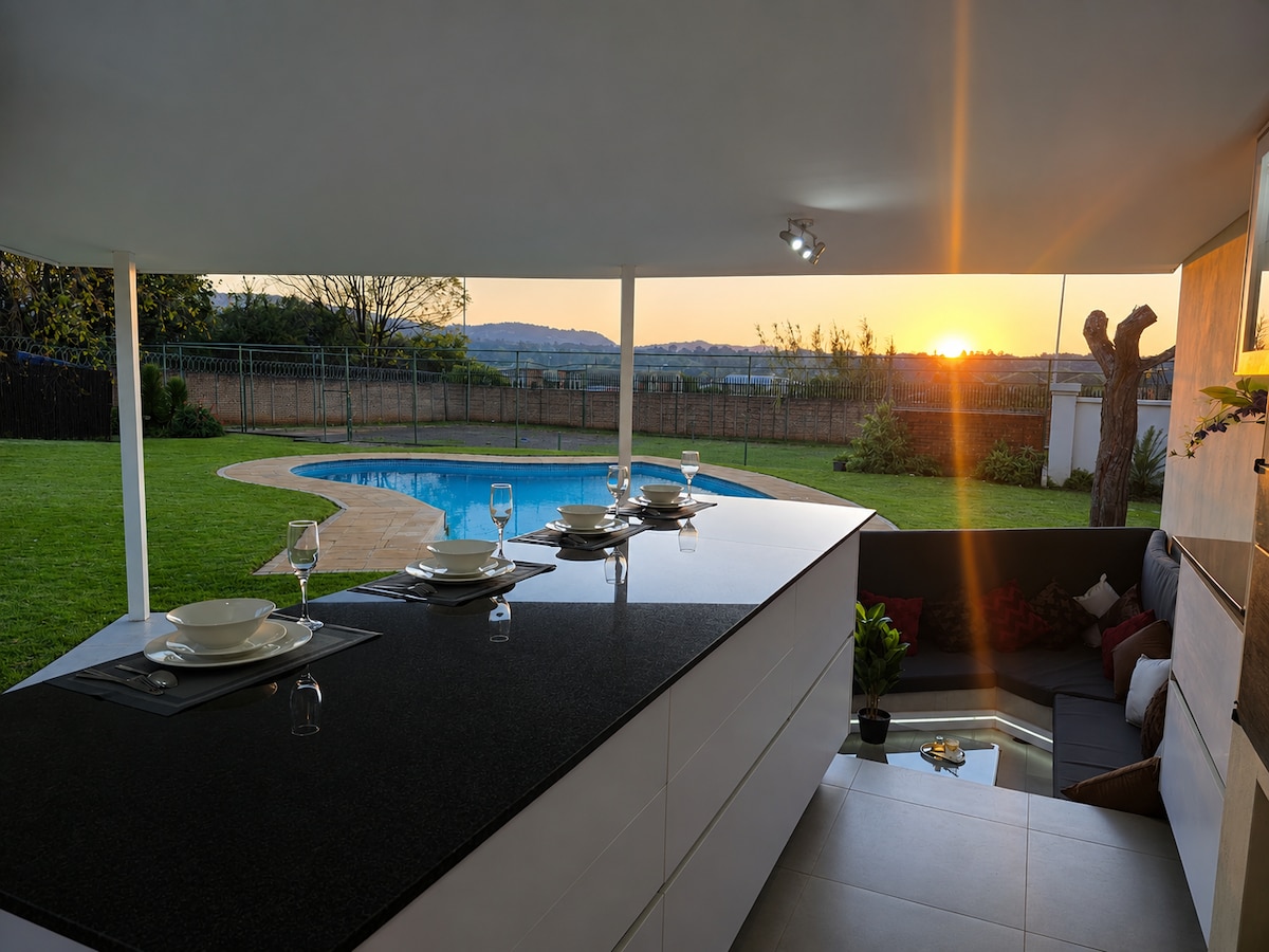 outdoor dining and BBQ area with sunken lounge by the pool