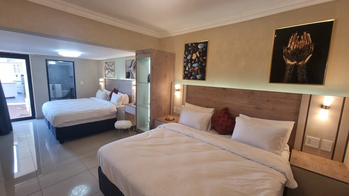 Large master bedroom with 2 large king sized beds with electric blankets, USB night stand outlets, ensuite bathroom and room darkening shades.