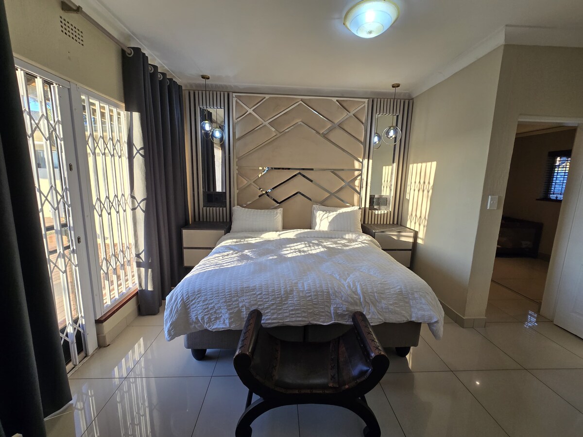 King sized bed with electric blanket, USB charging nightstands and room darkening shades.