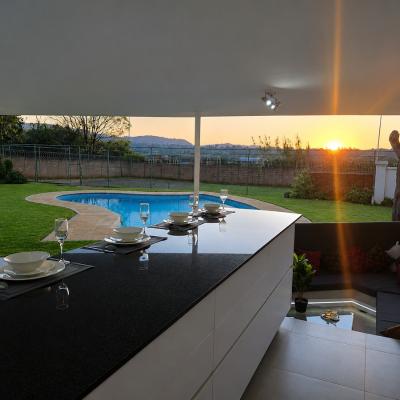 outdoor dining and BBQ area with sunken lounge by the pool