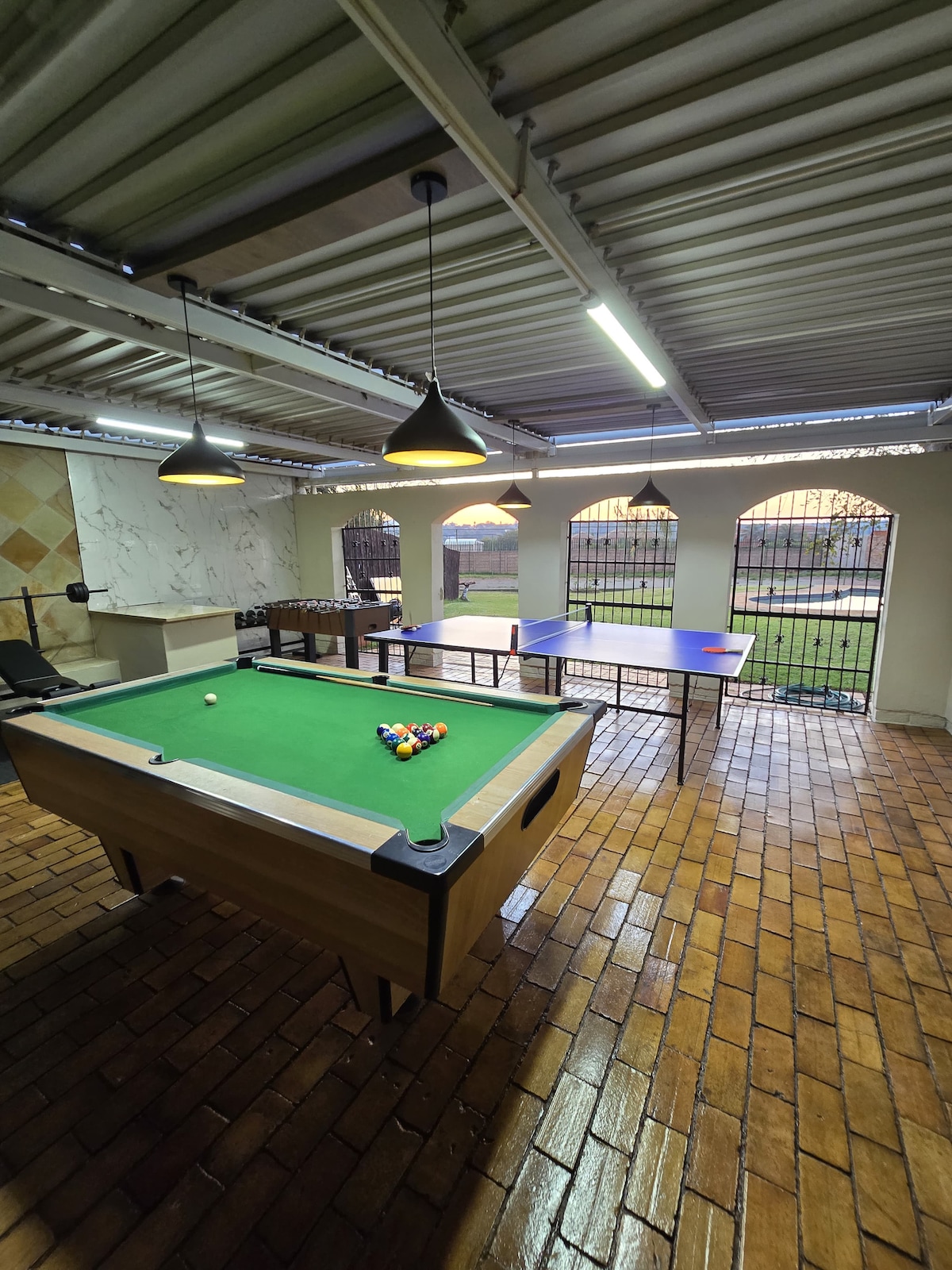 Large entertainment area will pool table, table tennis, foosball, and gym area with weights, cycle and treadmill.