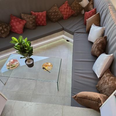 Sunken outdoor seating area by pool and outdoor braai area
