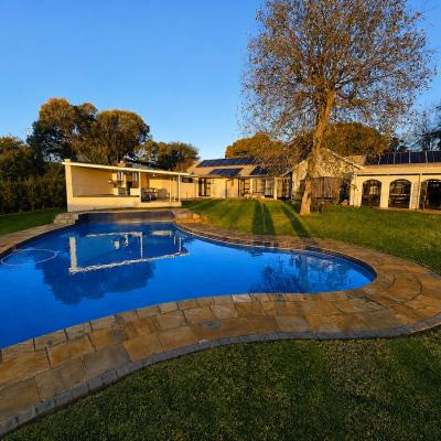 Large pool, garden and outdoor braai, seating and dining area.