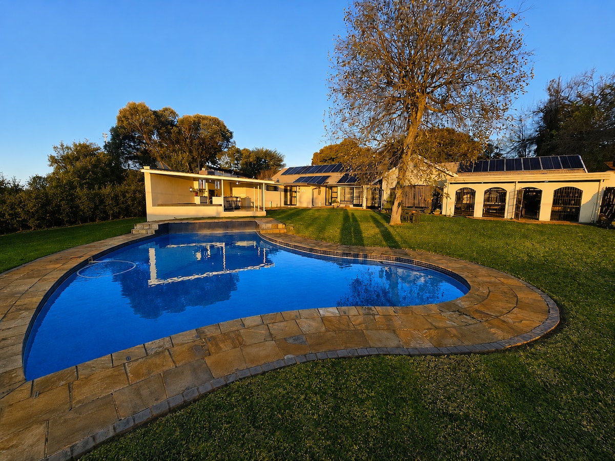 Large pool, garden and outdoor braai, seating and dining area.