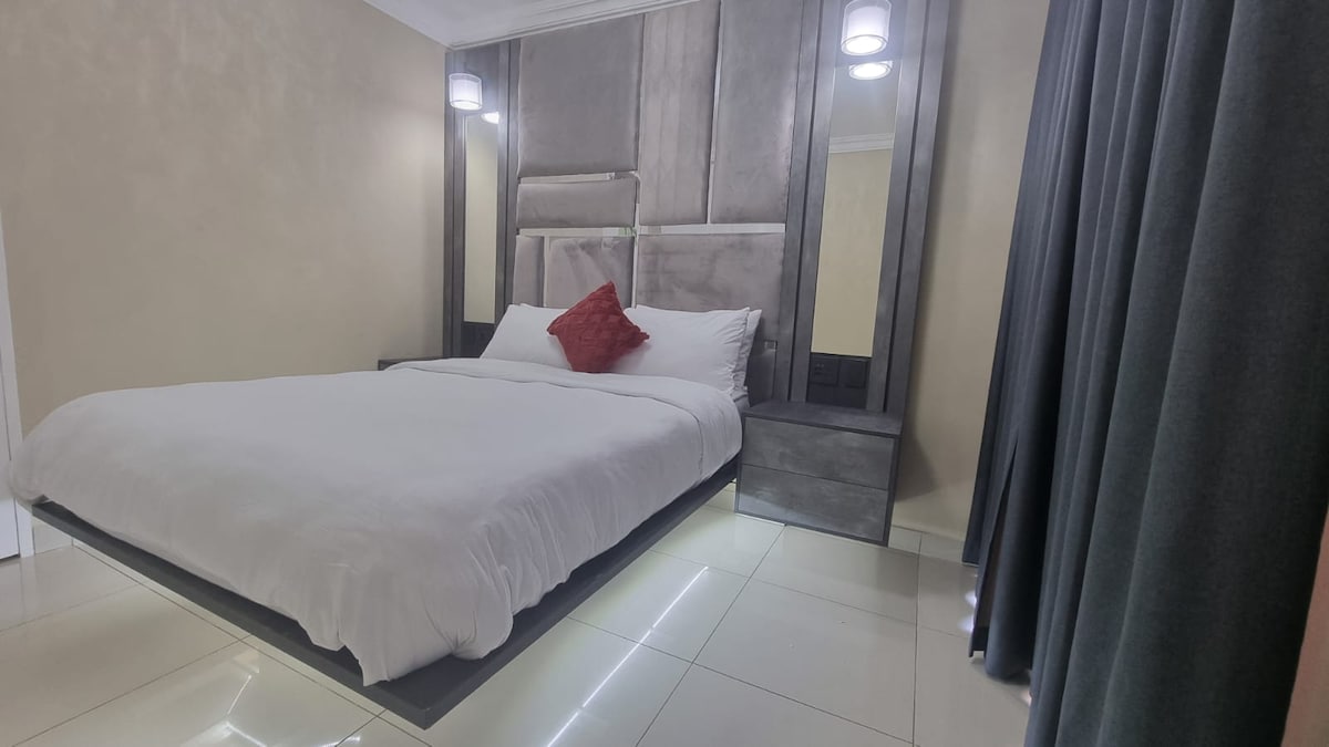 Floating LED lit queen sized bed with electric blanket, USB charging nightstands, ensuite bathroom and room darkening shades.