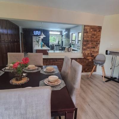 Dining table with open plan kitchen