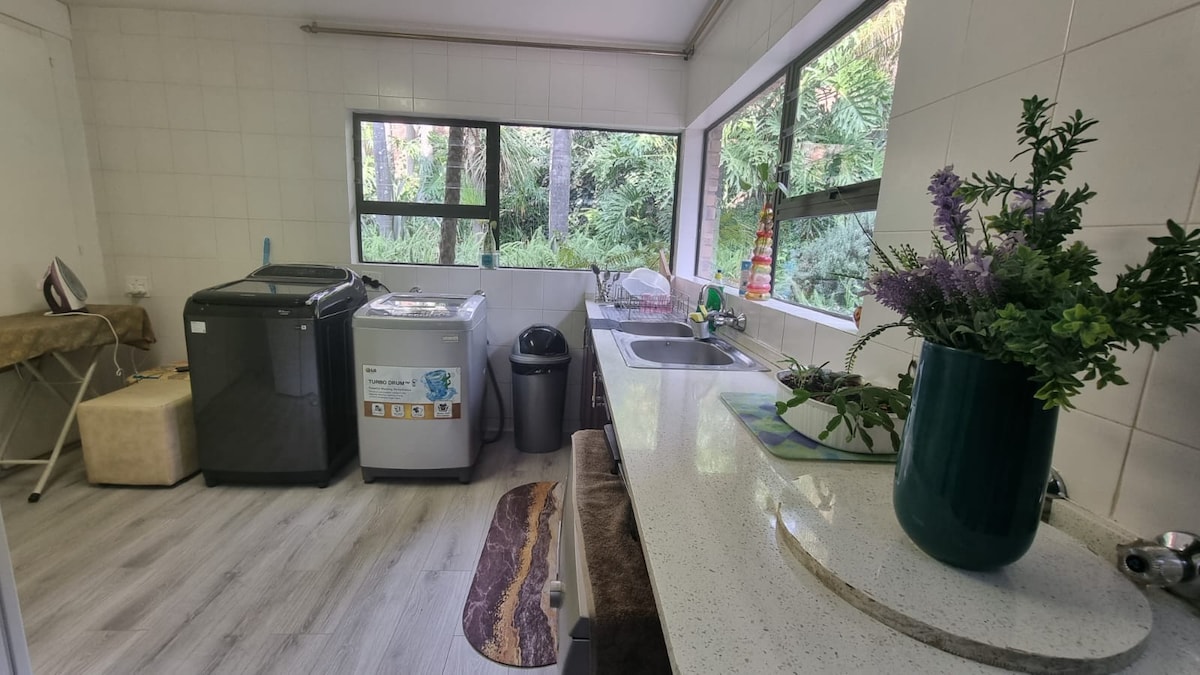 Laundry room with washing machines and dishwasher