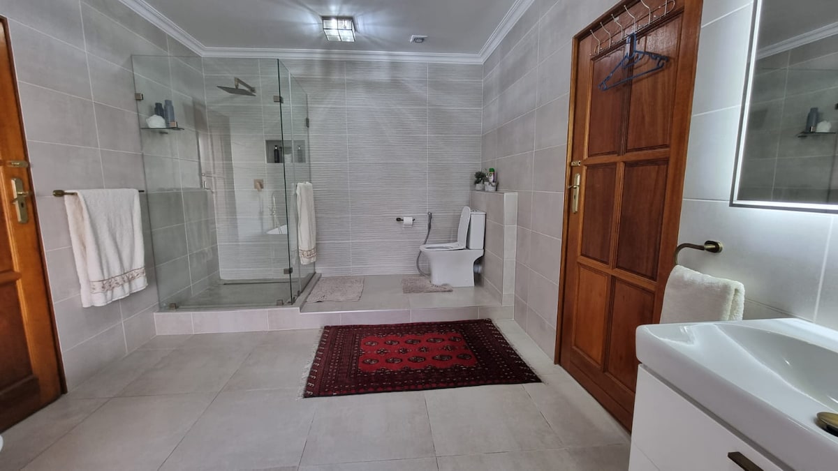 bathroom with shower and bathtub