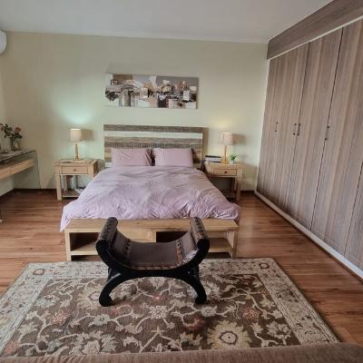Queen sized bed with electric blankets and seating couch and with a view to northern JHB.