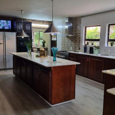 Open plan kitchen with all cooking utensils, gas stove, kettle, toaster, microwave and fridge