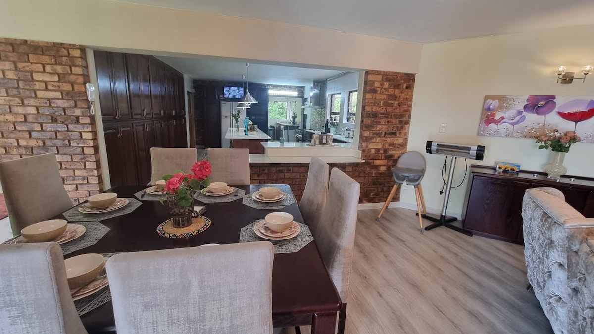 Dining table with open plan kitchen