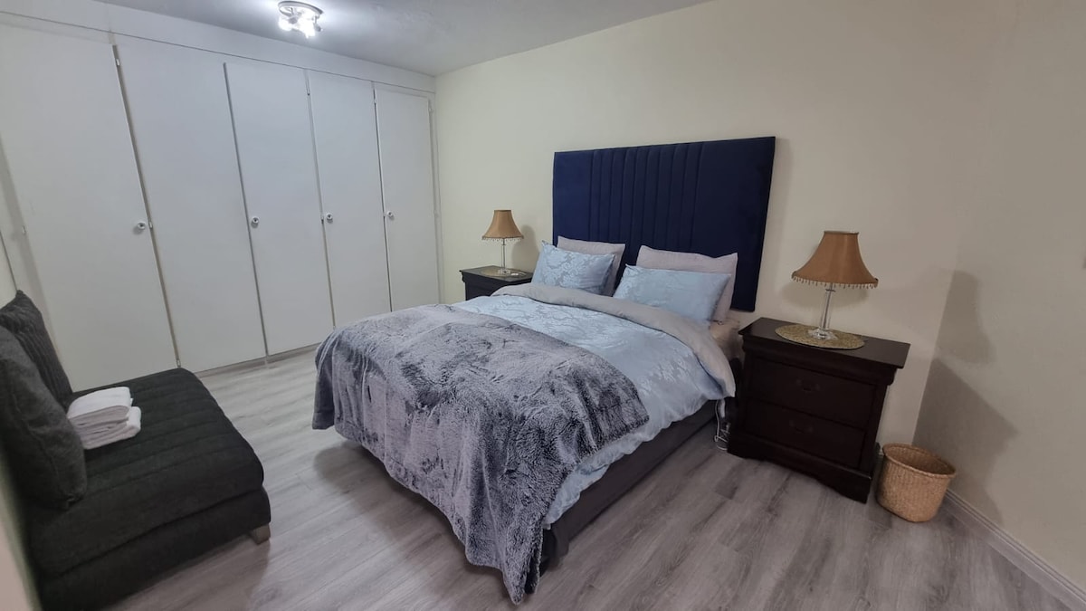 Master bedroom with queen sized bed and single bed.