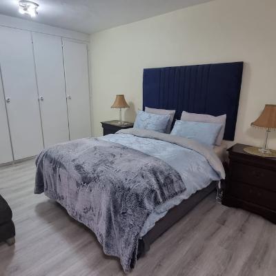 Master bedroom with queen sized bed and single bed.