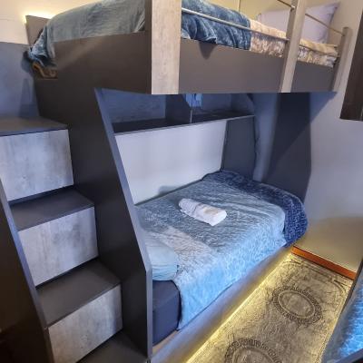 Four single bunk beds with LED lights and electric blankets. Beds has USB ports to charge devices.