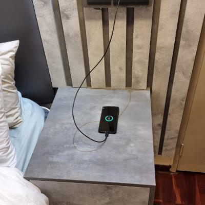 Super king size bed night stands have USB outlets for charging devices.
