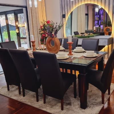 Eight seater dining room with LED lit table server with circular mirror.