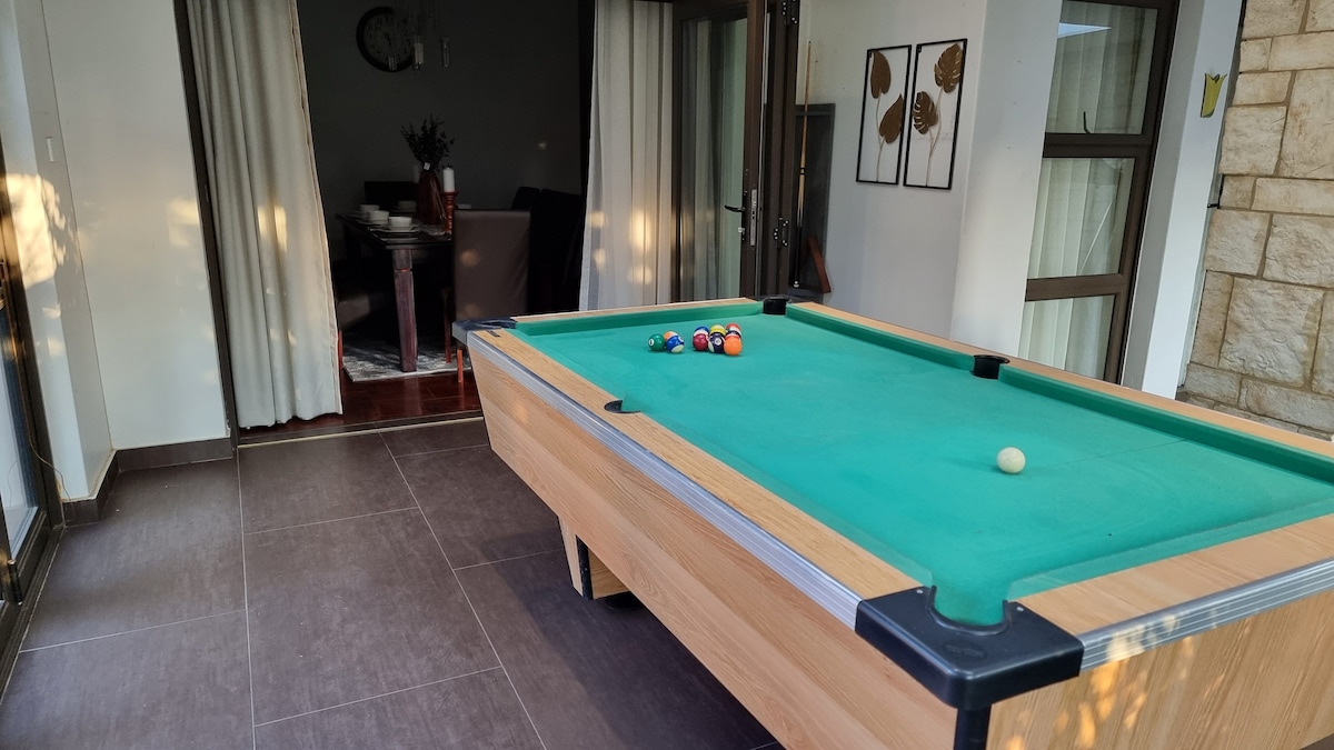 Pool table overlooking the pool and garden area