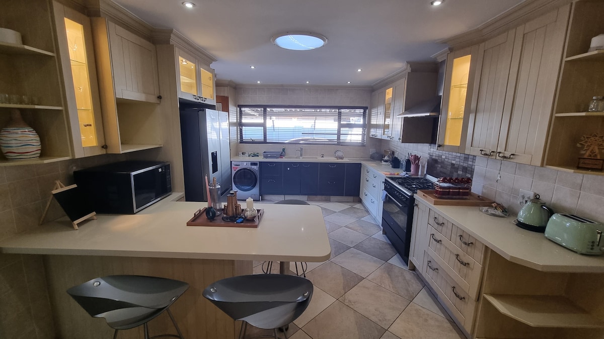 Fully stocked kitchen with gas stove and oven, double door fridge, microwave oven, kettle, toaster and washer/dryer combo washing machine. Power for fridge, stove and microwave oven is fed from solar powered battery inverter.