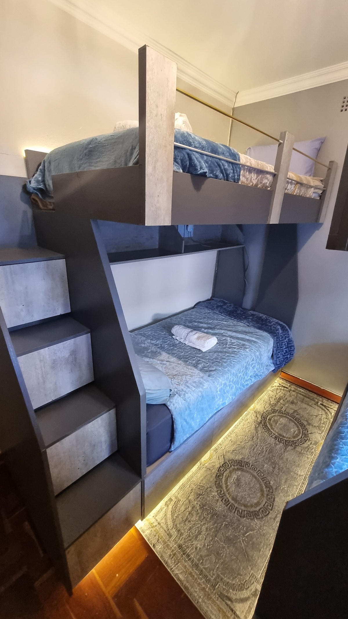 Four single bunk beds with LED lights and electric blankets. Beds has USB ports to charge devices.