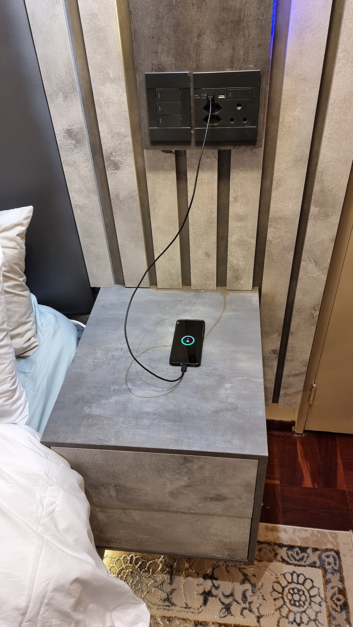 Super king size bed night stands have USB outlets for charging devices.