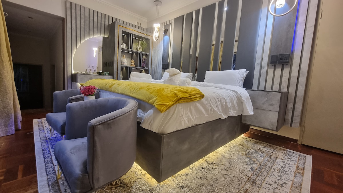 Super king size LED lit bed with dressing table overlooking the pool and garden area. 
