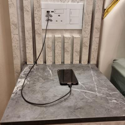 Queen sized bed has night stands with USB ports to charge devices.