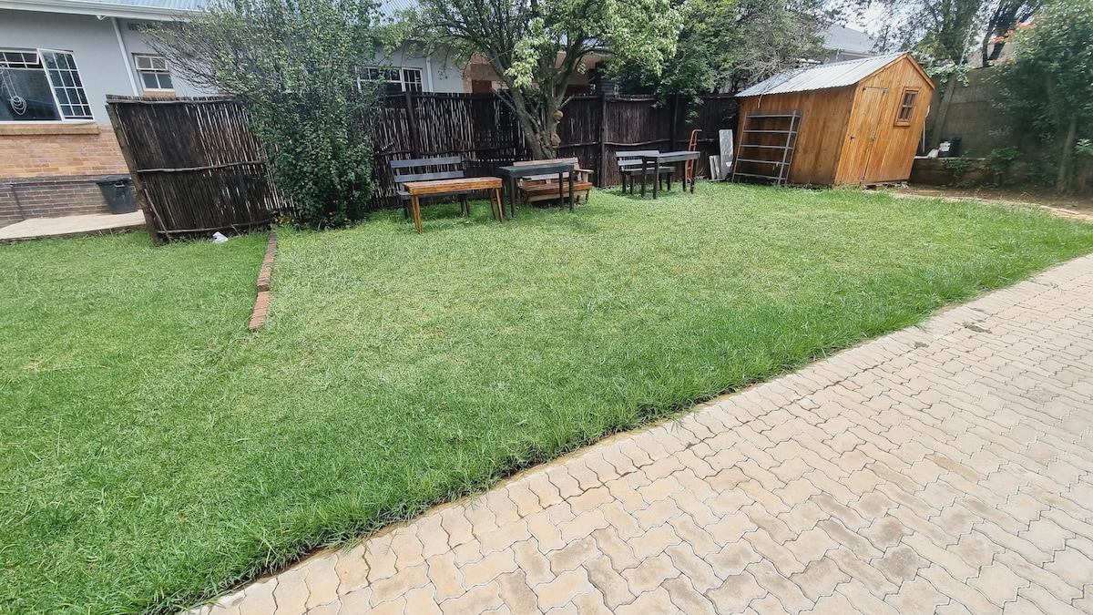Outdoor seating area under a plum tree