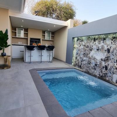 Outdoor entertainment area with fountain splash pool, outdoor kitchen and braai/bbq place.