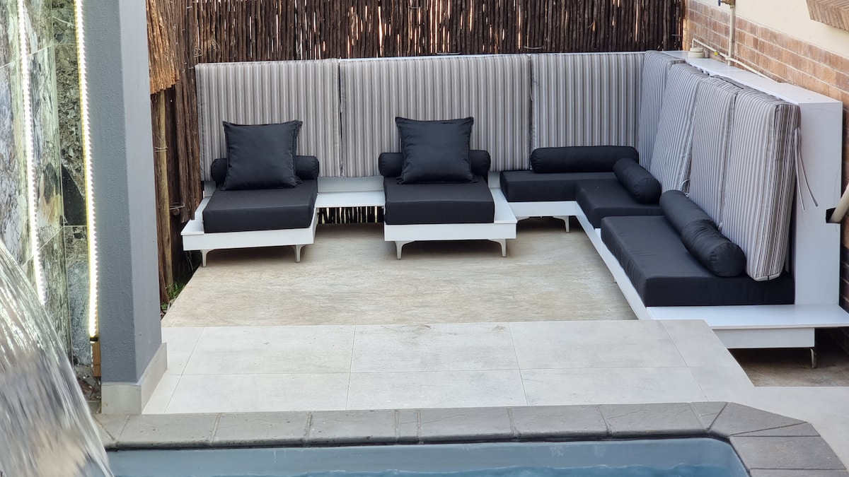 Outdoor day loungers and day beds overlooking the splash pool