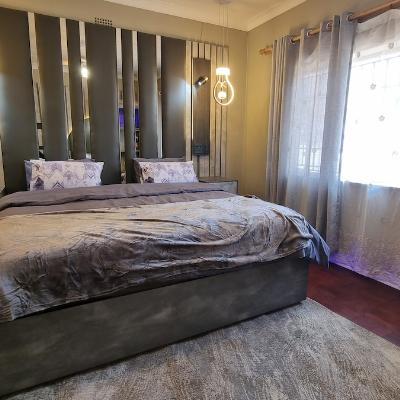 Super king size bed with USB plugs and LED spot reading lights.