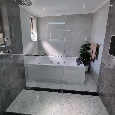 Massive bathroom with open shower and jacuzzi.