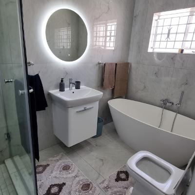 Full bathroom with shower cubicle and freestanding bathtub.