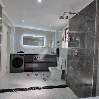 Bathroom with washer/dryer combo washing machine